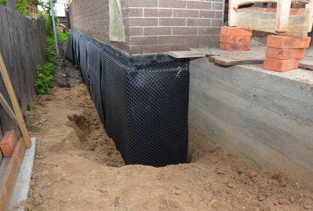 Happy homeowners after waterproofing job in Algoma
